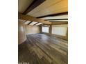 Spacious living room with wood floors, ceiling beams, and plenty of natural light at 3330 E Main St # 323, Mesa, AZ 85213