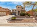 Two-story home featuring a turret entry, a balcony, desert landscaping, and a two-car garage at 3891 E Melrose St, Gilbert, AZ 85297