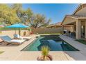 Backyard pool with lounge chairs and manicured landscaping at 39526 N White Tail Ln, Anthem, AZ 85086