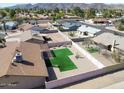 Aerial view of a backyard featuring a pristine lawn, mature trees, and privacy fence at 4826 E Navajo Cir, Phoenix, AZ 85044