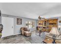 Cozy living room with neutral walls, wood-look floors, and custom built in shelving at 4826 E Navajo Cir, Phoenix, AZ 85044