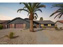 Contemporary home featuring desert landscaping, a spacious garage, and a welcoming walkway at 5726 E Woodridge Dr, Scottsdale, AZ 85254