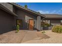 Inviting front entrance featuring a solid wooden door, desert landscaping, and modern house numbers at 5726 E Woodridge Dr, Scottsdale, AZ 85254