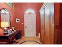 Welcoming foyer with decorative mirror, wood accent furniture, and arched stained-glass transom window at 5825 N 12Th St # 3, Phoenix, AZ 85014