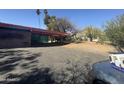 Exterior view showing covered parking, desert landscaping and paved driveway at 6528 N Hillside Dr, Paradise Valley, AZ 85253