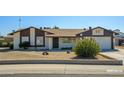 Charming single-Gathering home boasting desert landscaping and a two-car garage at 7335 W Mission Ln, Peoria, AZ 85345