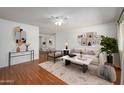 Staged living room featuring modern decor and plush neutral toned furniture at 7335 W Mission Ln, Peoria, AZ 85345