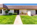 Charming townhouse featuring a well-manicured lawn and inviting walkway to the front door at 8101 N 107Th Ave # 23, Peoria, AZ 85345