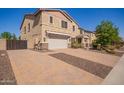 Front exterior of a two-story home with brick driveway and desert landscaping at 9382 W Louise Dr, Peoria, AZ 85383