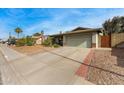 Long concrete driveway leading to a single-story home with mature landscaping at 947 N Saffron --, Mesa, AZ 85205