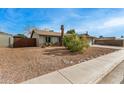 Residential home with front yard with mature bushes and gravel at 947 N Saffron --, Mesa, AZ 85205