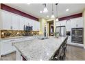 Spacious kitchen with granite countertops, stainless steel appliances, and a large island with bar seating at 10049 E Topaz Ave, Mesa, AZ 85212