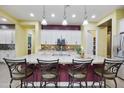 Large kitchen island featuring granite countertops and barstool seating, illuminated by pendant lighting at 10049 E Topaz Ave, Mesa, AZ 85212