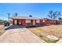 Attractive single-story brick house with a covered carport and mature trees at 1007 W 5Th St, Mesa, AZ 85201