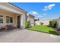 Cozy patio with a table set and artificial turf, ideal for relaxation at 10145 E Cintron Dr, Mesa, AZ 85212