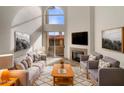 Bright living room featuring high ceilings, fireplace, and a sliding glass door to a patio at 10410 N Cave Creek Rd # 2119, Phoenix, AZ 85020