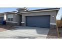 View of home's exterior showing concrete driveway and two-car garage door at 10619 W Sonrisas St, Tolleson, AZ 85353