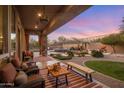Backyard with covered patio, desert landscaping, pool, and lounge seating at 10886 E Ludlow Dr, Scottsdale, AZ 85255