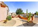 Cozy outdoor seating area with desert plants in a low maintenance, peaceful courtyard setting at 17204 W Cordova Ct, Surprise, AZ 85387