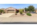 Charming home featuring desert landscaping, a two-car garage, and a well-maintained front yard at 17204 W Cordova Ct, Surprise, AZ 85387