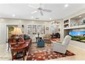 Comfortable living room with bright light, ceiling fan, tile floors and a calming color palette at 17204 W Cordova Ct, Surprise, AZ 85387