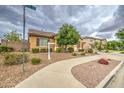 Cozy single-story home with xeriscaping, mature trees, and a well-manicured lawn on a quiet street at 18618 E Mockingbird Dr, Queen Creek, AZ 85142