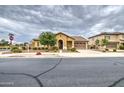 Street view of a one-story home featuring desert landscaping, and an attached garage with a driveway at 18618 E Mockingbird Dr, Queen Creek, AZ 85142