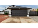 Close up view of the two car garage with a black door and the home's address at 18829 N 15Th Pl, Phoenix, AZ 85024