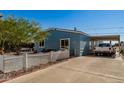 Lovely single-story home with carport, desert landscaping and a white picket fence enhancing its curb appeal at 19041 N Pierson Rd, Peoria, AZ 85373