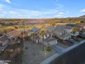 Stunning aerial view of desert homes and a manicured golf course on a sunny day at 22491 W Woodlands Ave, Buckeye, AZ 85326