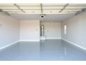 Spacious garage featuring an epoxy floor and a water heater at 27145 N 147Th Ave, Surprise, AZ 85387