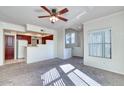 Comfortable living room features an open floor plan to the kitchen, carpeted floors, and a ceiling fan at 295 N Rural Rd # 273, Chandler, AZ 85226