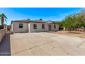Wide driveway and home featuring a well-maintained exterior and a neatly landscaped front yard at 3035 W Pierce St, Phoenix, AZ 85009