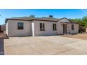 Wide driveway and home featuring a well-maintained exterior and a neatly landscaped front yard at 3035 W Pierce St, Phoenix, AZ 85009