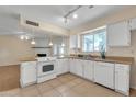 Galley kitchen featuring white appliances, tile flooring and butcher block countertops at 3349 E Carmel Ave, Mesa, AZ 85204