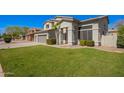 Inviting front yard of a two-story home featuring lush green grass, mature trees, and a three-car garage at 3730 E Diamond Ct, Gilbert, AZ 85297