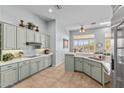 Bright kitchen featuring modern appliances, light blue cabinetry, and a breakfast nook at 42047 N Moss Springs Rd, Anthem, AZ 85086
