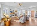 Spacious living room featuring hardwood floors, fireplace, and many windows for natural light at 42047 N Moss Springs Rd, Anthem, AZ 85086