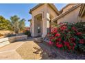 Grand entrance featuring desert landscaping, arched entryway, and a charming bench at 4803 W Buckskin Trl, Phoenix, AZ 85083