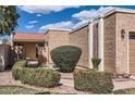 The cozy residence is surrounded by desert landscaping including sculpted bushes and decorative stone at 482 Leisure World --, Mesa, AZ 85206