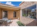 A charming outdoor patio space offers tile flooring and tranquil view through surrounding windows at 482 Leisure World --, Mesa, AZ 85206