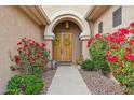 Inviting front door with vibrant floral landscaping creating a warm welcome at 5210 E Calle De Baca --, Cave Creek, AZ 85331
