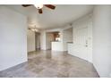 Open-concept living room with tiled floors offering seamless transition to dining and kitchen area at 5303 N 7Th St # 101, Phoenix, AZ 85014