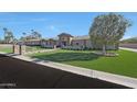 Stunning single-story home featuring manicured landscaping, stone accents, and a beautiful lawn at 6615 E Shea Blvd, Scottsdale, AZ 85254