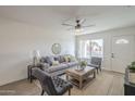 Cozy living room featuring neutral walls, a ceiling fan, and ample natural light at 6808 W Sierra St, Peoria, AZ 85345