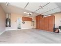 Spacious garage with ample storage cabinets and room for vehicles at 7157 E Ivyglen Cir, Mesa, AZ 85207