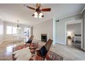 Bright living area with stylish decor, fireplace, and a ceiling fan for added comfort at 750 E Northern Ave # 1079, Phoenix, AZ 85020