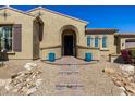 Inviting front entrance with an arched doorway, brick steps, and blue potted plants at 7576 W Quail Ave, Glendale, AZ 85308