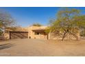 Exterior view of a home with stucco siding, a two-car garage, and desert landscaping at 9121 W Quail W Trl, Queen Creek, AZ 85144