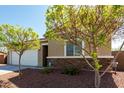 Charming single-story home showcasing a two-car garage, desert landscaping, and stone accents at 101 W Seven Seas Dr, Casa Grande, AZ 85122